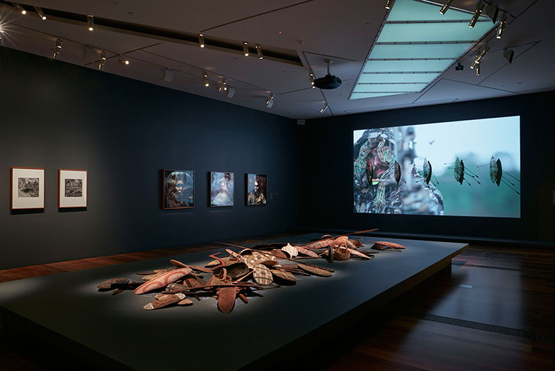 Installation view, (Left to right) James Tylor, Leah King-Smith, Steaphan Paton, Cloaked Combat 2, 2013, HD video. Installation view, Colony: Frontier Wars, NGV Australia