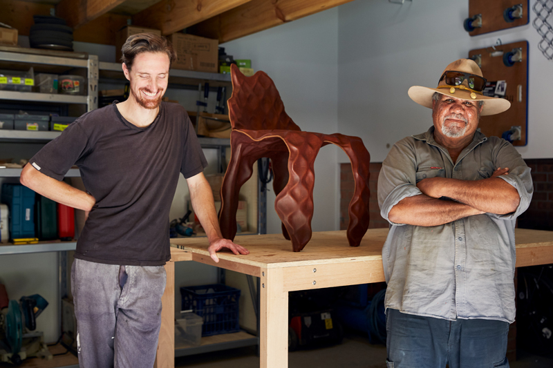 Designer Trent Jansen and Mangkaja Artist John Nargoodah in the Sydney studio in 2019 with their Ngumu Janka Warnti chair exhibited in Melbourne and Sydney. Photo credit Romella Periera