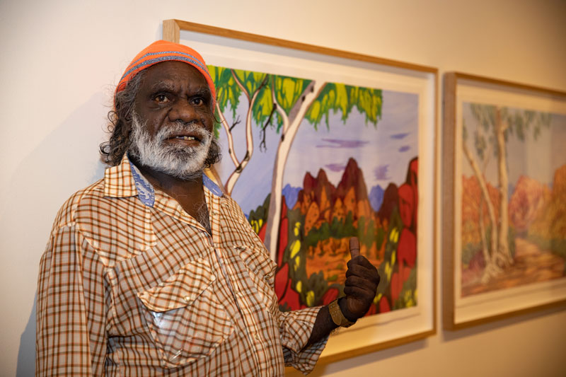 Mervyn Rubuntja in front of Mt Zeil, Central Australia. Photo by Oliver Eclipse. Courtesy Araluen Arts Centre, Alice Springs