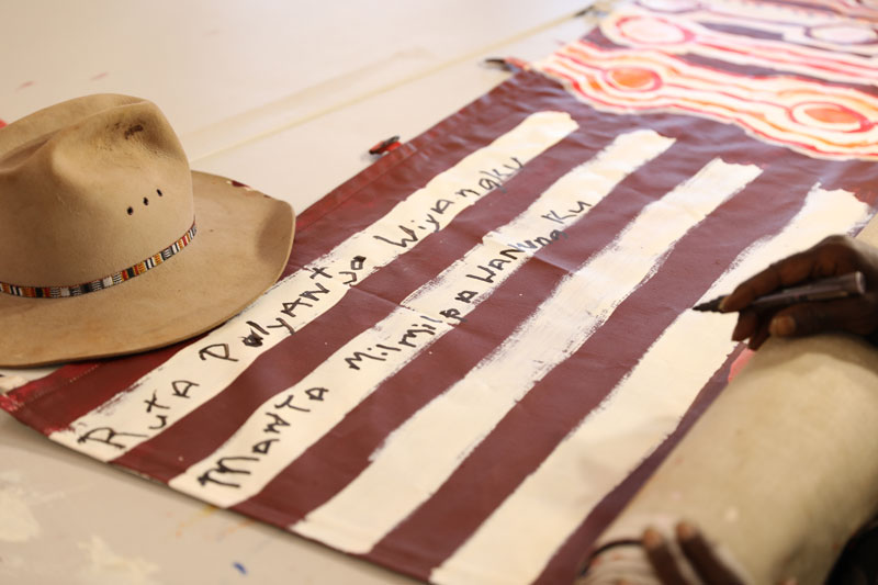 Kunmanara working on Kamantaku Tjukurpa wiya (The government doesn’t have Tjukurpa) for the Museum of Contemporary Art Australia, 2018. Courtesy Mimili Maku Arts